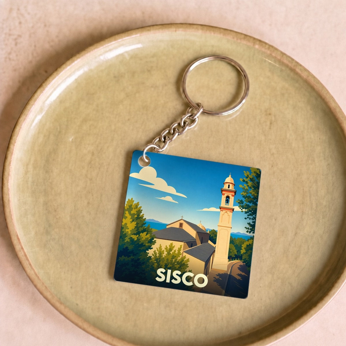 Porte-clés souvenir de la ville de Sisco avec une illustration stylisée.