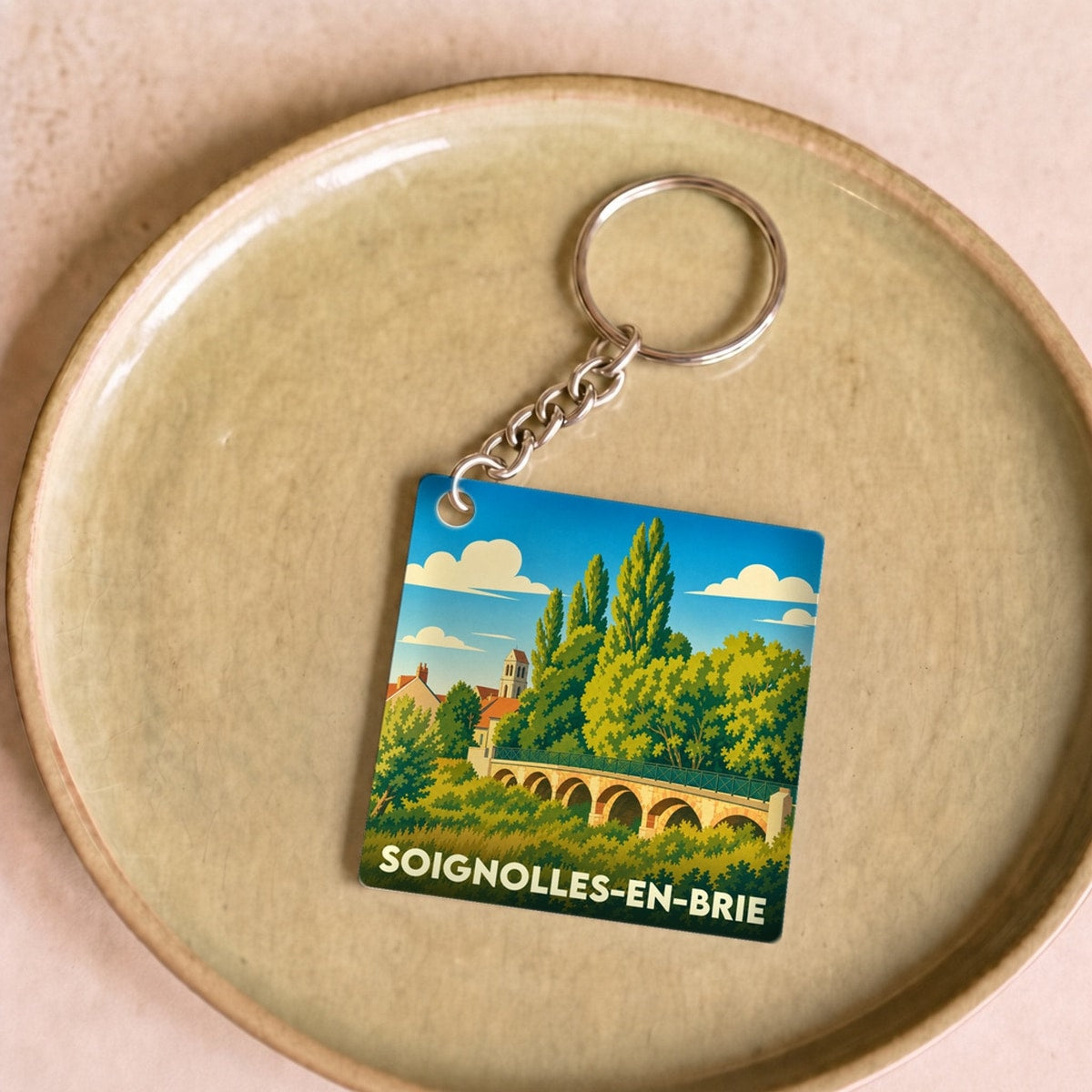 Porte-clés souvenir de la ville de Soignolles-en-Brie avec une illustration stylisée.