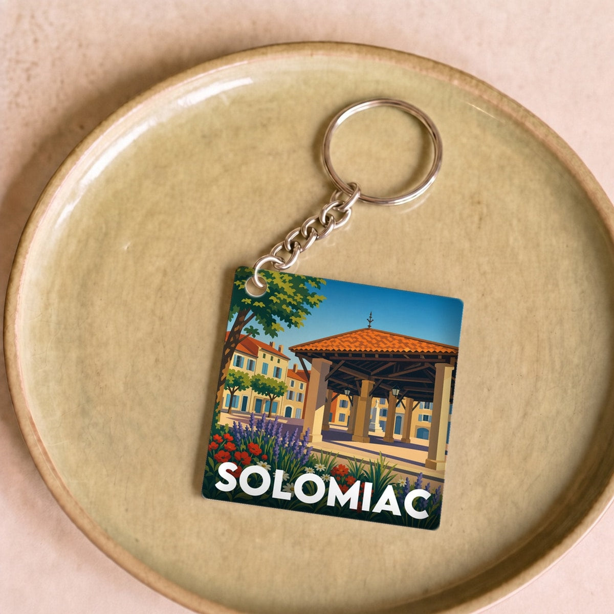 Porte-clés souvenir de la ville de Solomiac avec une illustration stylisée.