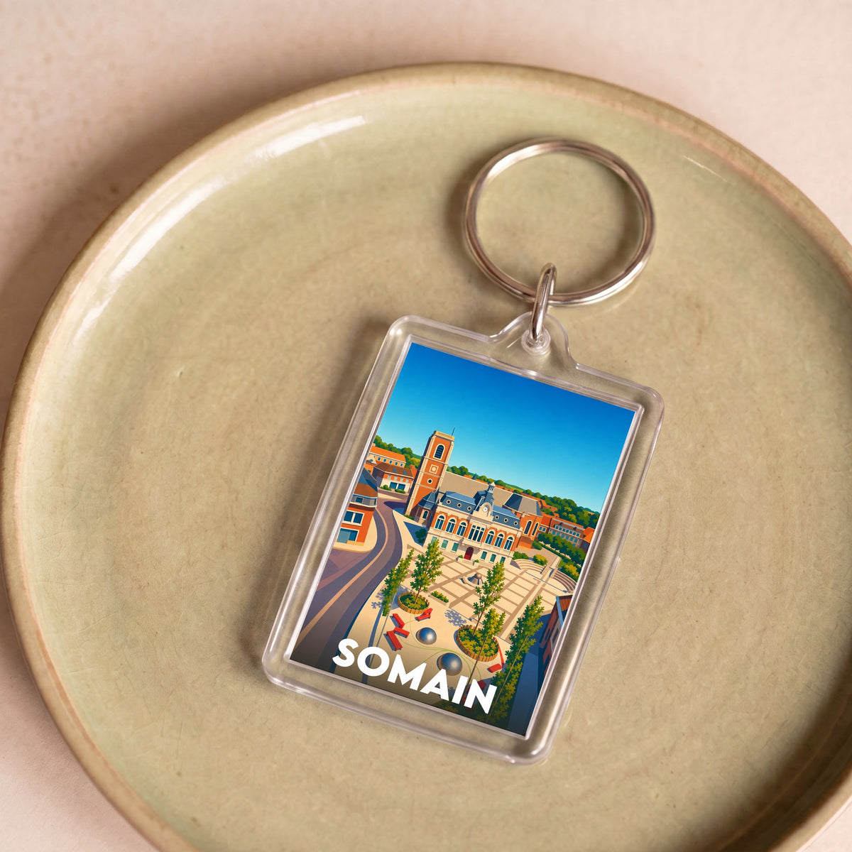 Porte-clés souvenir de la ville de Somain avec une illustration stylisée.