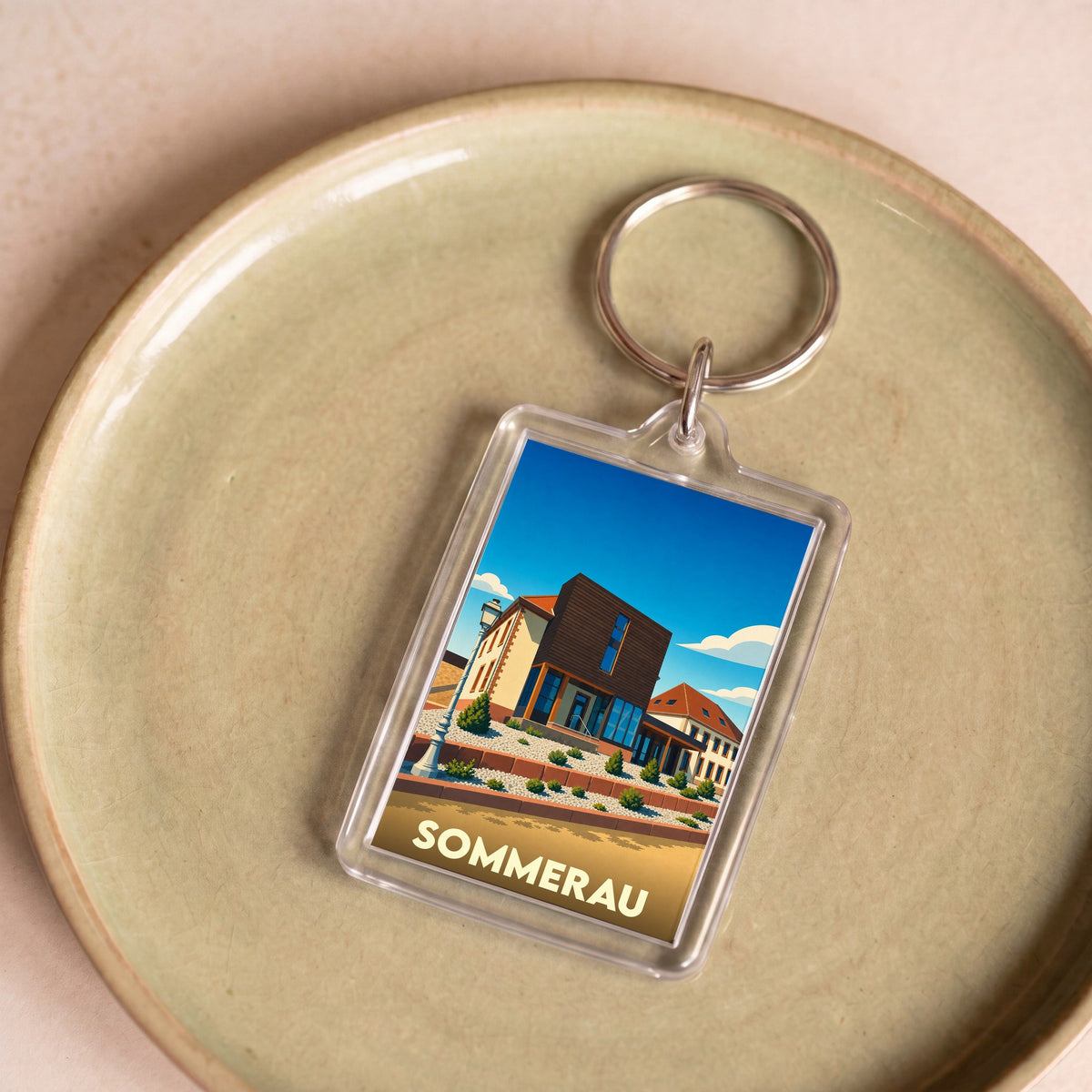 Porte-clés souvenir de la ville de Sommerau avec une illustration stylisée.