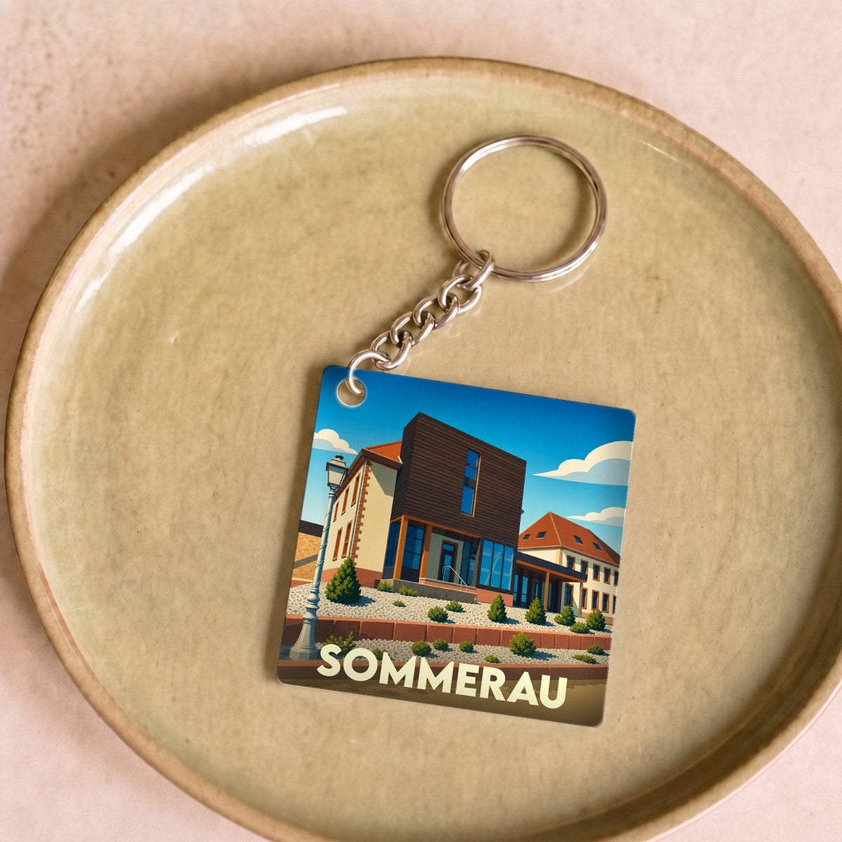 Porte-clés souvenir de la ville de Sommerau avec une illustration stylisée.