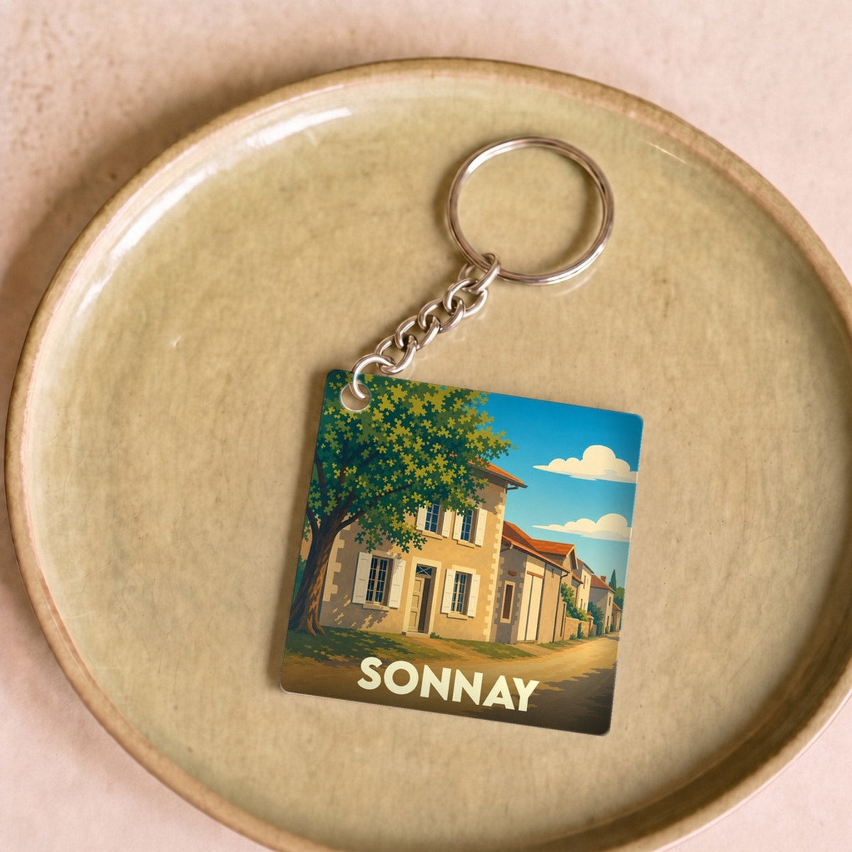 Porte-clés souvenir de la ville de Sonnay avec une illustration stylisée.