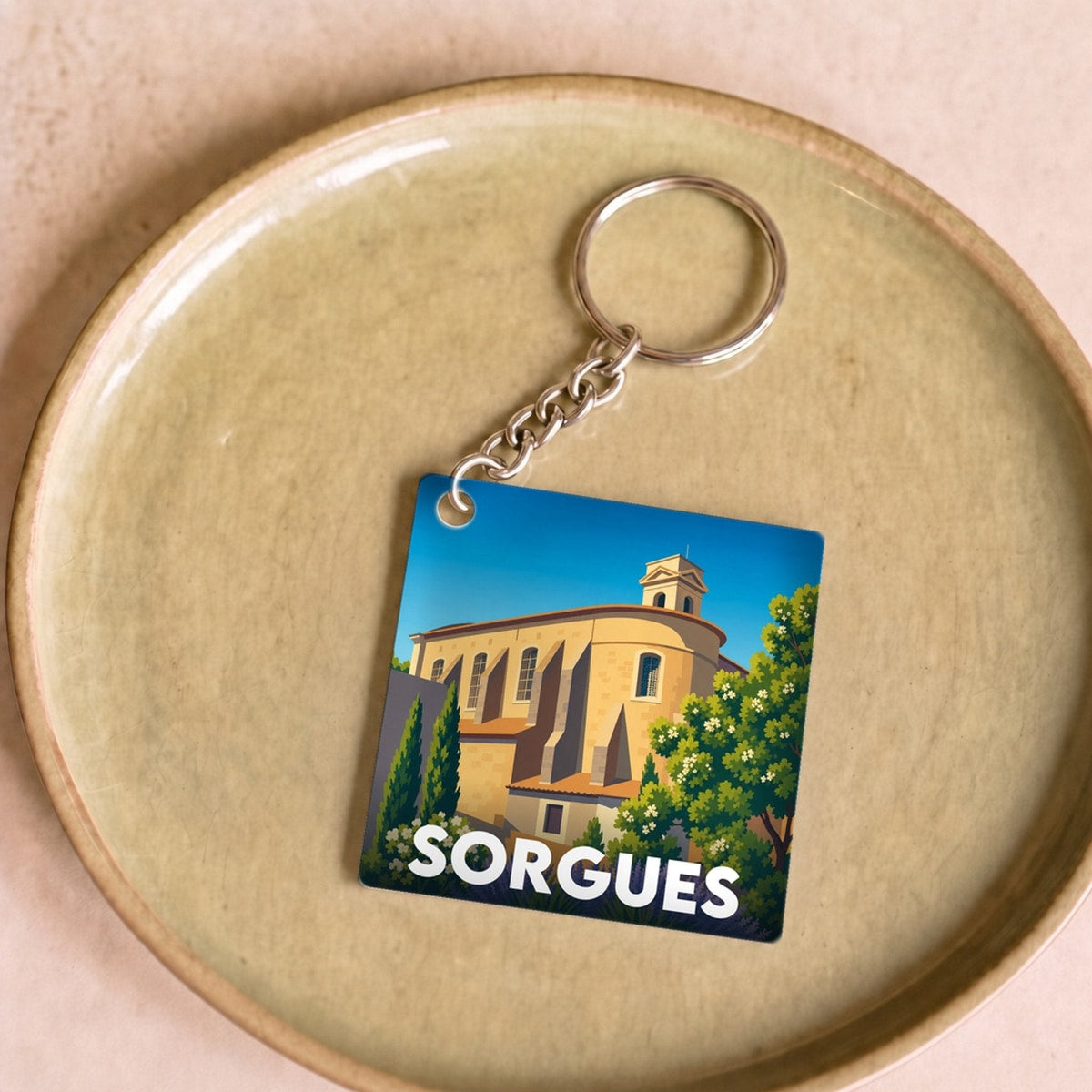 Porte-clés souvenir de la ville de Sorgues avec une illustration stylisée.