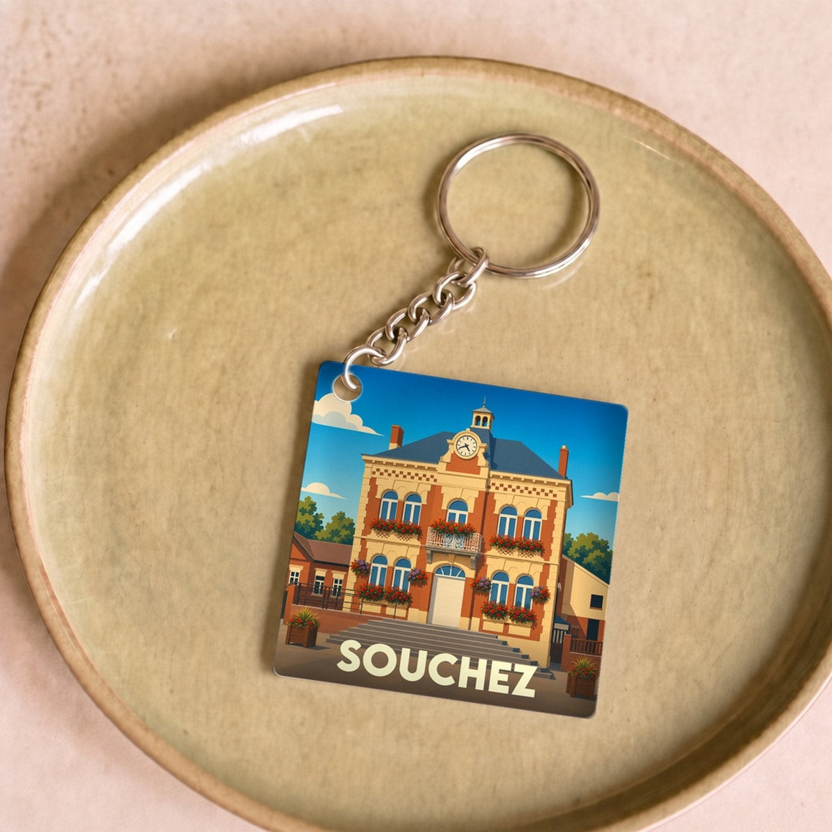 Porte-clés souvenir de la ville de Souchez avec une illustration stylisée de son hôtel de ville.