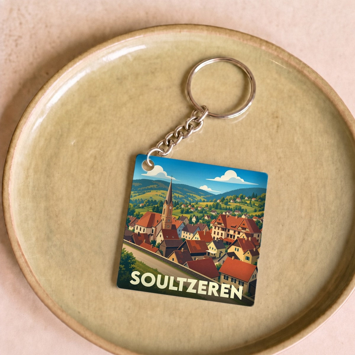 Porte-clés souvenir de la ville de Soultzeren avec une illustration stylisée.