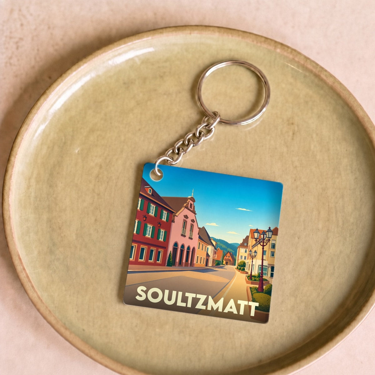 Porte-clés souvenir de la ville de Soultzmatt avec une illustration stylisée.