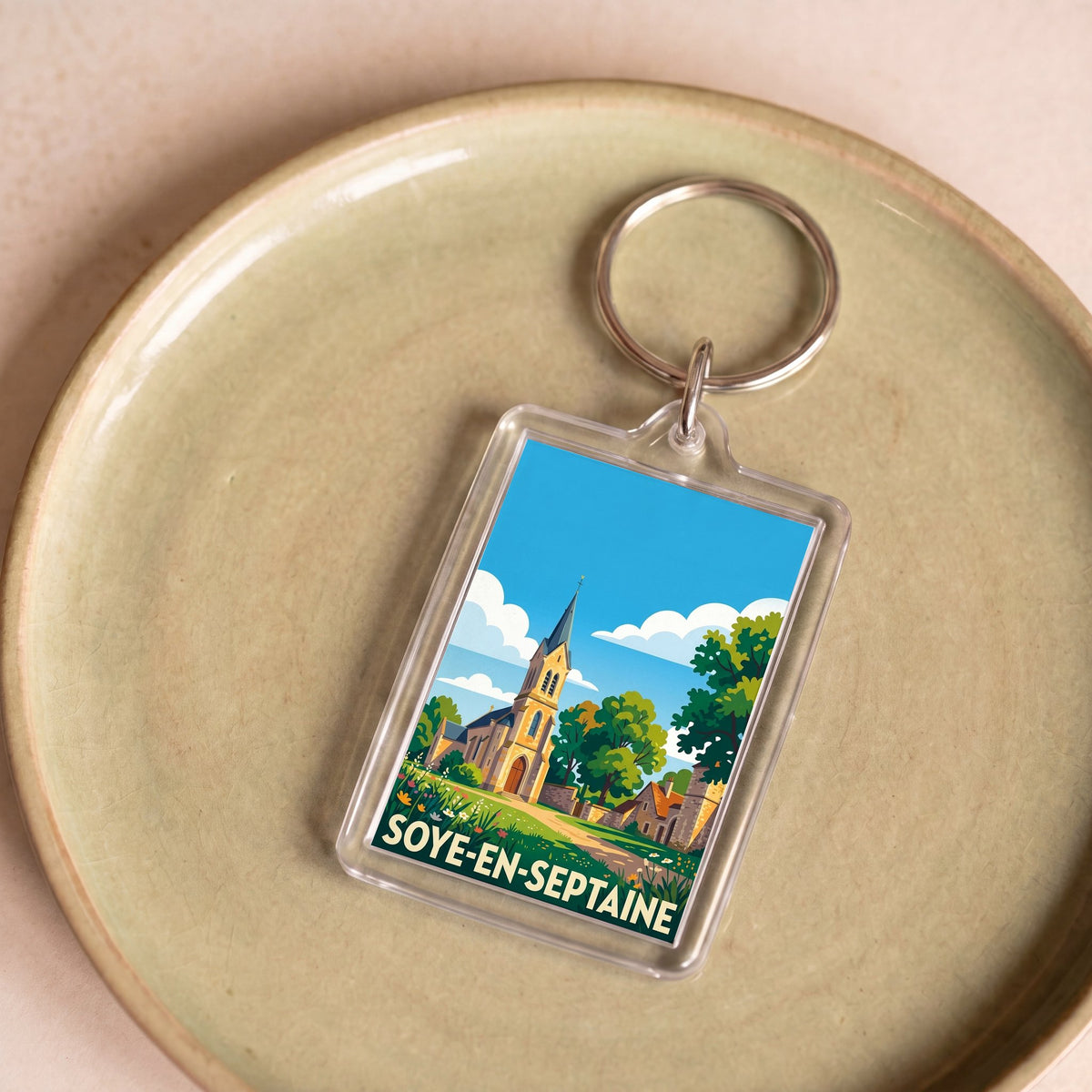 Porte-clés souvenir de la ville de Soye-en-Septaine avec une illustration stylisée.