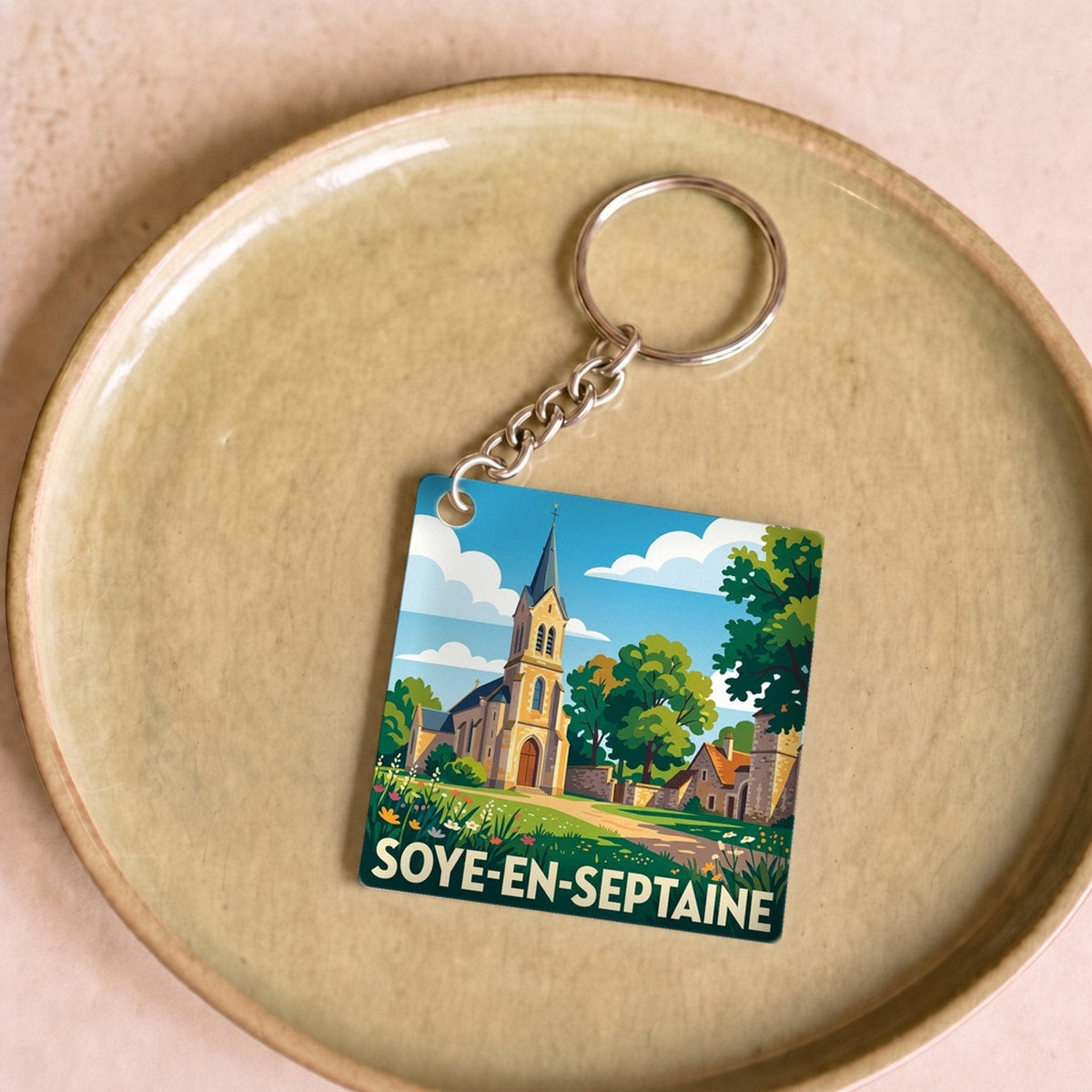 Porte-clés souvenir de la ville de Soye-en-Septaine avec une illustration stylisée.