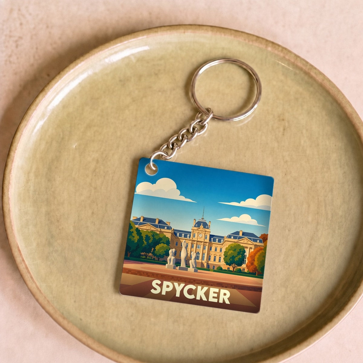 Porte-clés souvenir de la ville de Spycker avec une illustration stylisée.