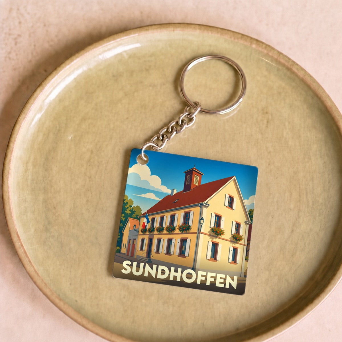 Porte-clés souvenir de la ville de Sundhoffen avec une illustration stylisée.