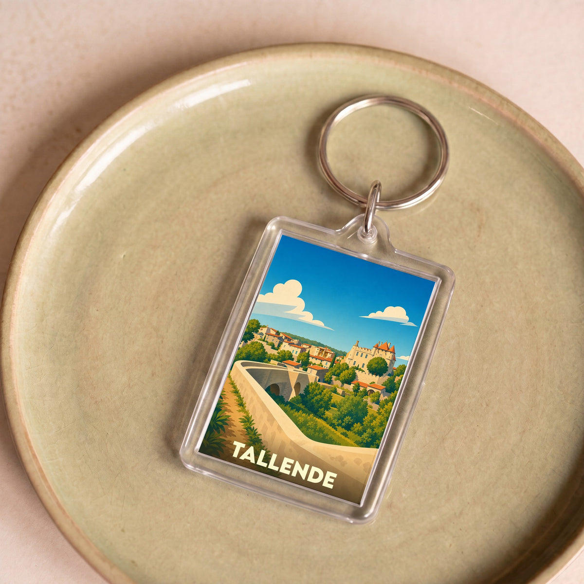 Porte-clés souvenir de la ville de Tallende avec une illustration stylisée.