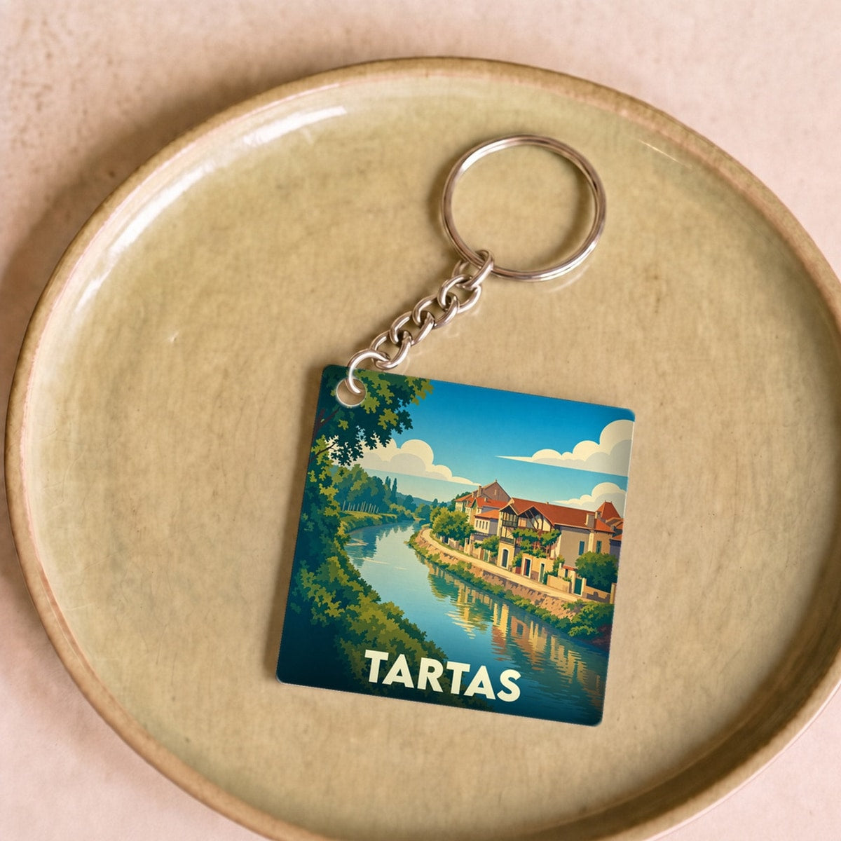 Porte-clés souvenir de la ville de Tartas avec une illustration stylisée des bords de la Midouze.