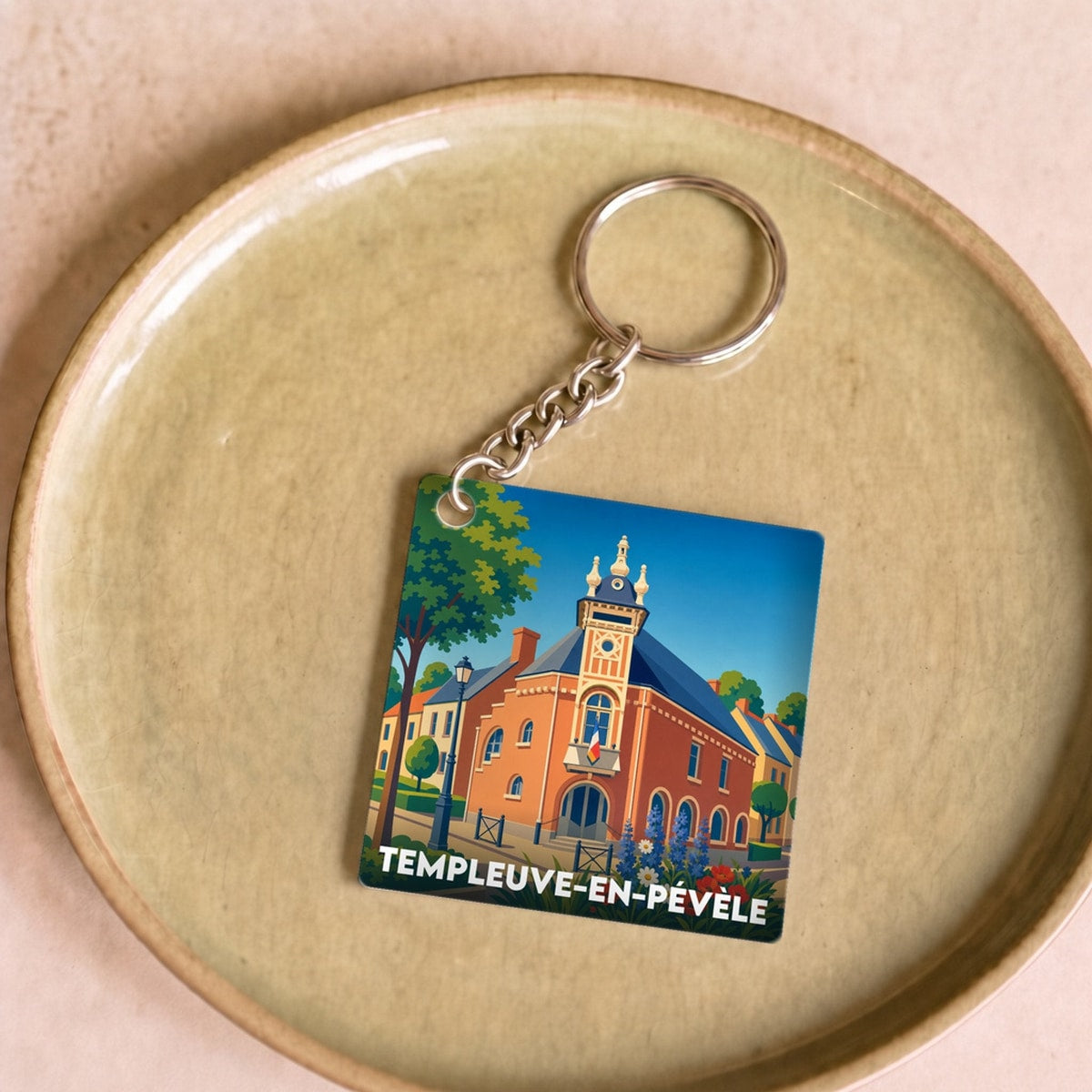 Porte-clés souvenir de la ville de Templeuve-en-Pévèle avec une illustration stylisée.