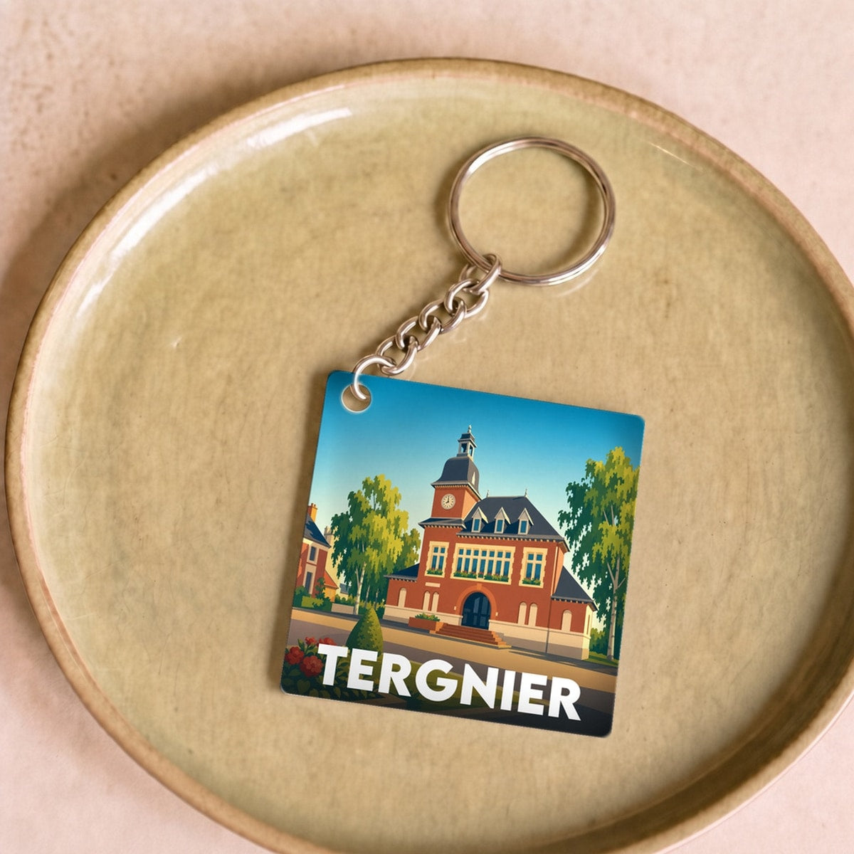 Porte-clés souvenir de la ville de Tergnier avec une illustration stylisée.