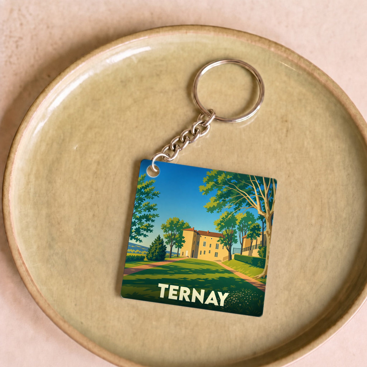 Porte-clés souvenir de la ville de Ternay avec une illustration stylisée.