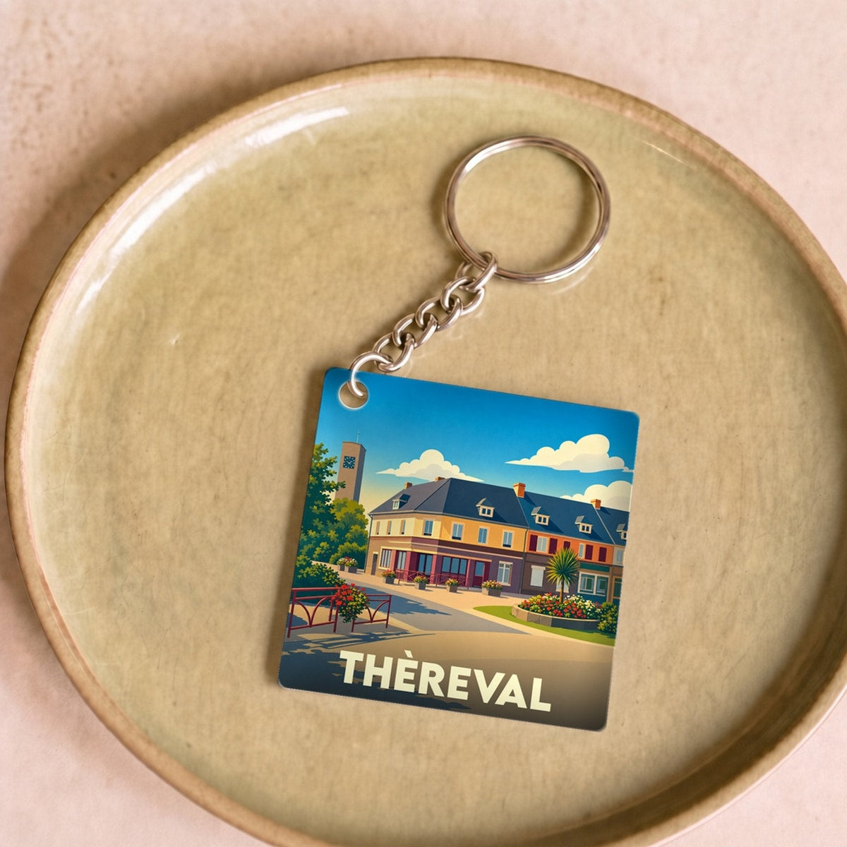Porte-clés souvenir de la ville de Thèreval avec une illustration stylisée.