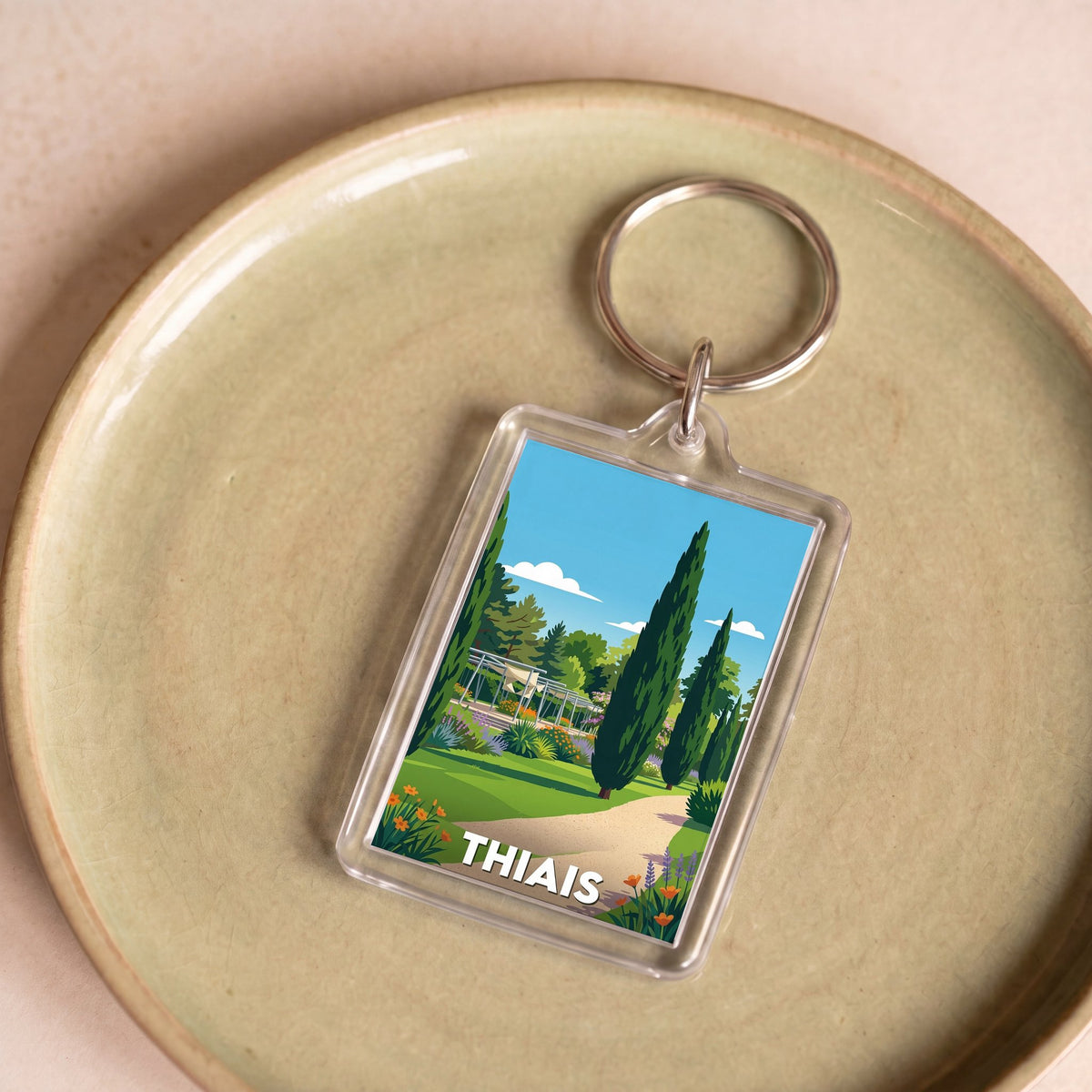 Porte-clés souvenir de la ville de Thiais avec une illustration stylisée.