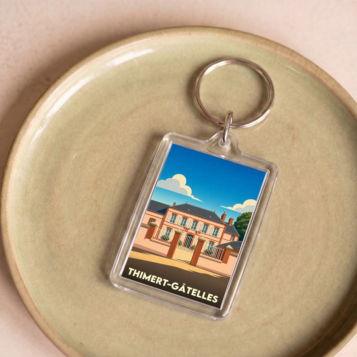 Porte-clés souvenir de la ville de Thimert-Gâtelles avec une illustration stylisée.