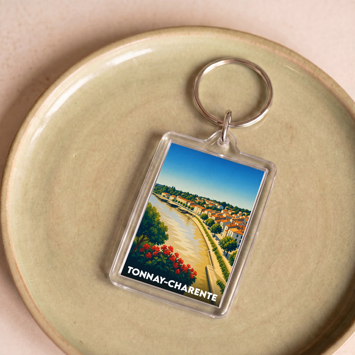 Porte-clés souvenir de la ville de Tonnay-Charente avec une illustration stylisée.