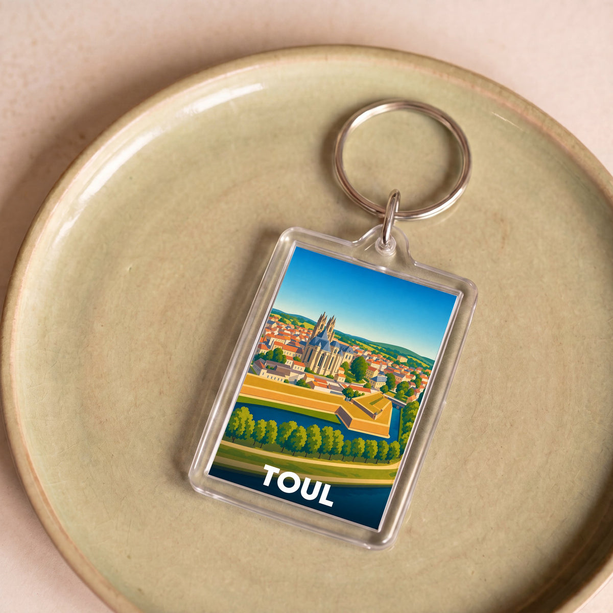 Porte-clés souvenir de la ville de Toul avec une illustration stylisée.