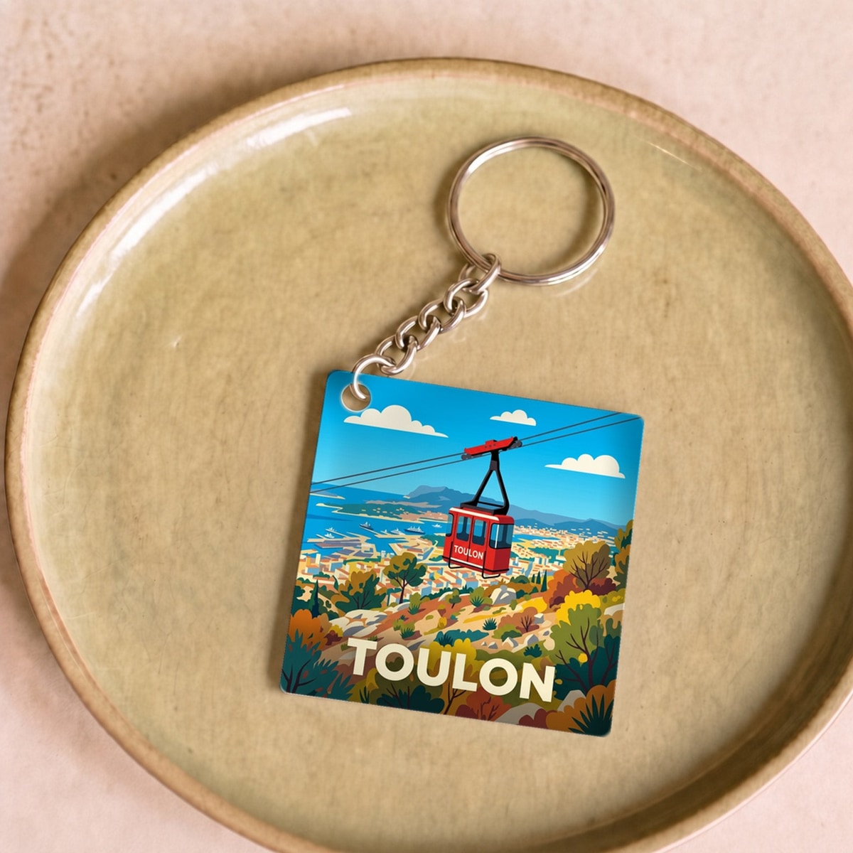 Porte-clés souvenir de la ville de Toulon avec une illustration stylisée du téléphérique.