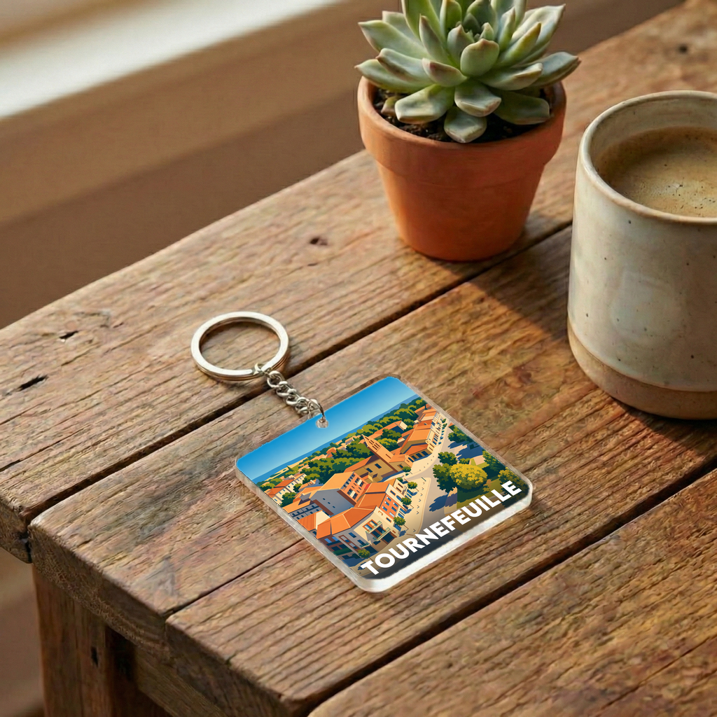 Porte-clés souvenir de la ville de Tournefeuille avec une illustration stylisée.