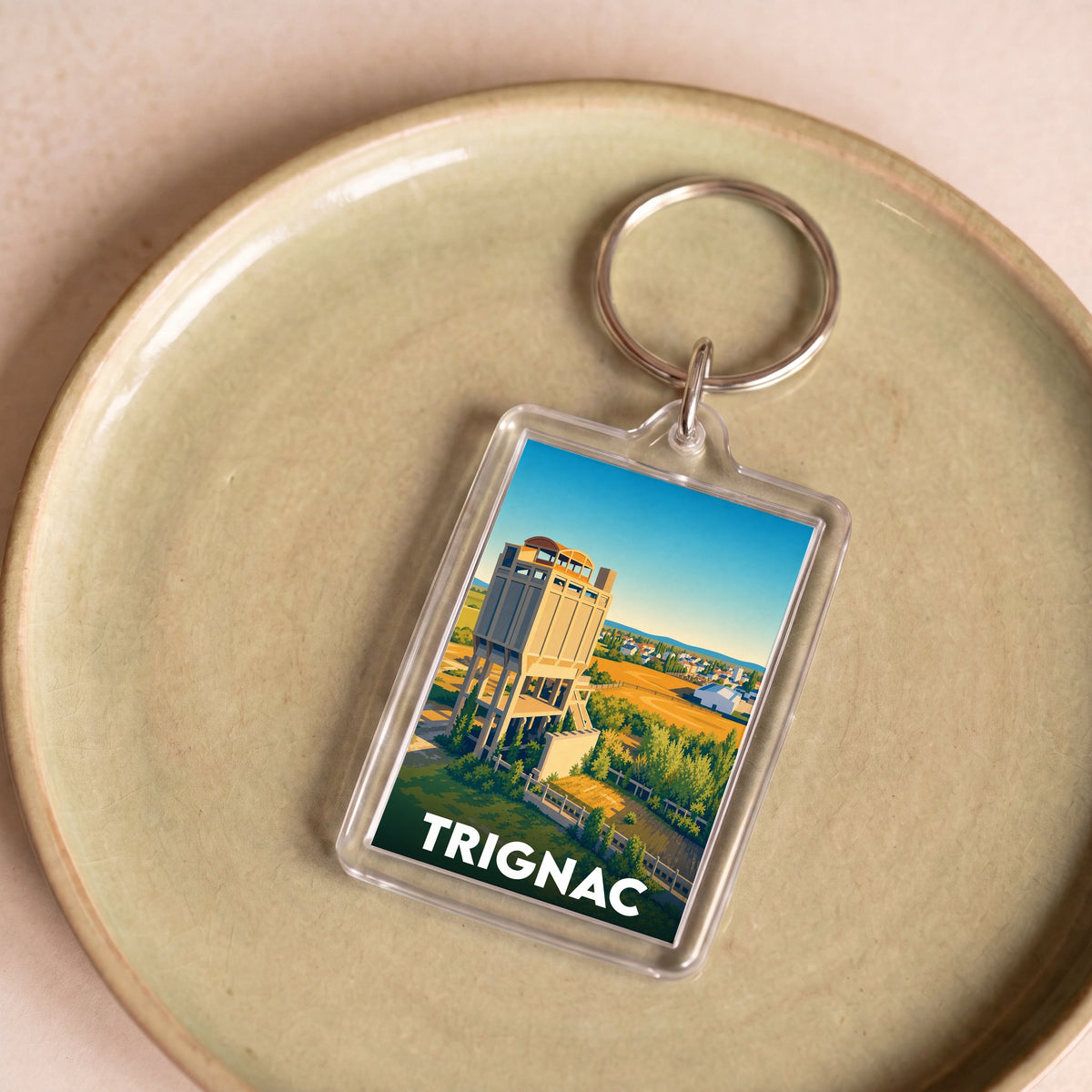 Porte-clés souvenir de la ville de Trignac avec une illustration stylisée de son patrimoine industriel.