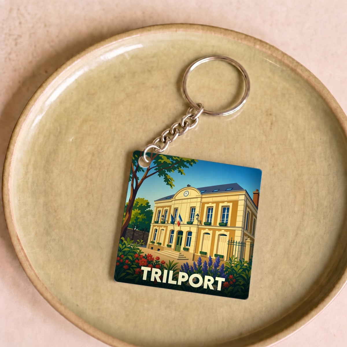 Porte-clés souvenir de la ville de Trilport avec une illustration stylisée de sa mairie.