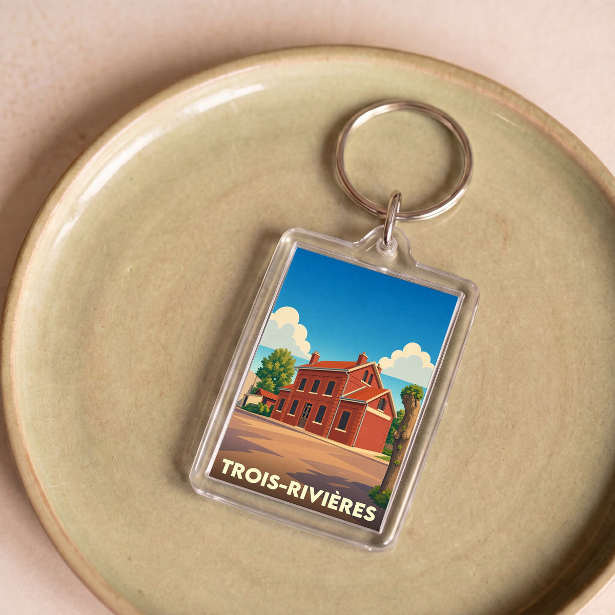 Porte-clés souvenir de la ville de Trois-Rivières avec une illustration stylisée.