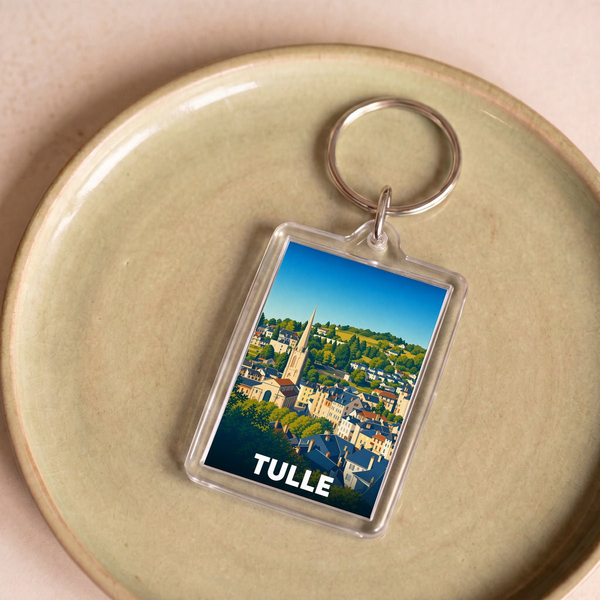 Porte-clés souvenir de la ville de Tulle avec une illustration stylisée.