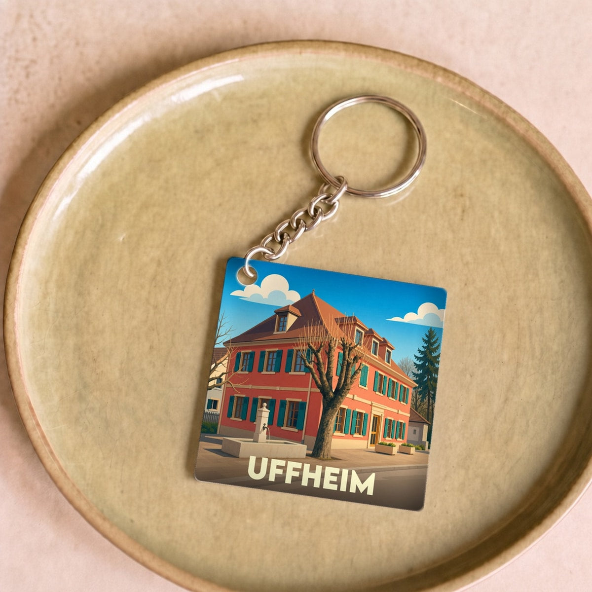 Porte-clés souvenir de la ville d'Uffheim avec une illustration stylisée.