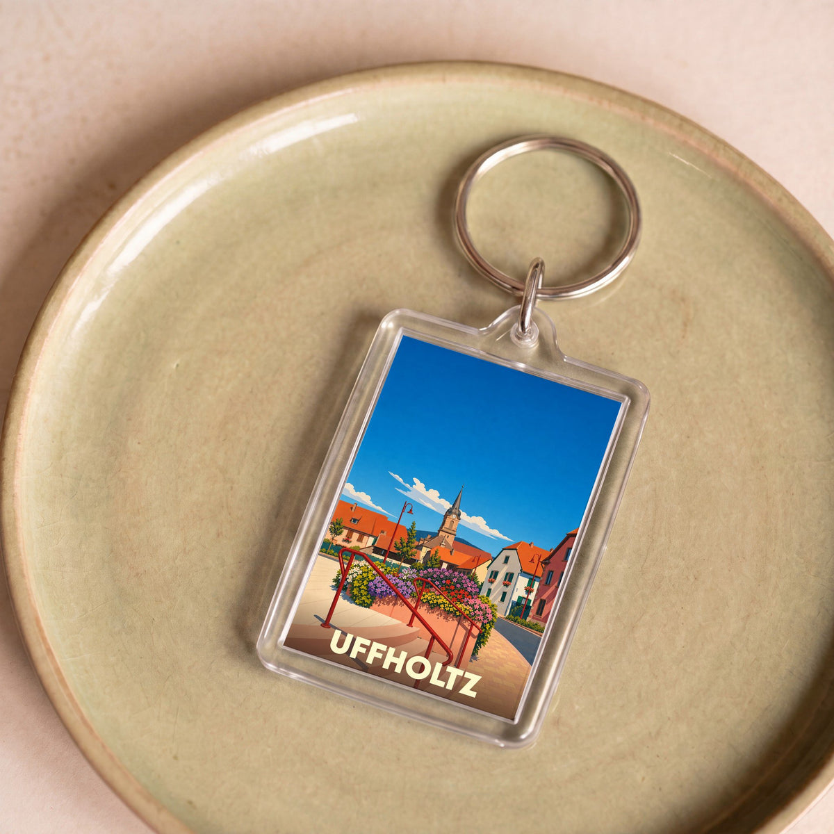 Porte-clés souvenir de la ville d'Uffholtz avec une illustration stylisée.