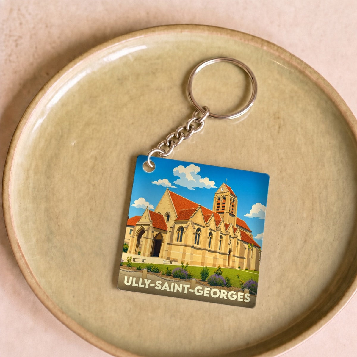 Porte-clés souvenir de la ville d'Ully-Saint-Georges avec une illustration stylisée de son église.