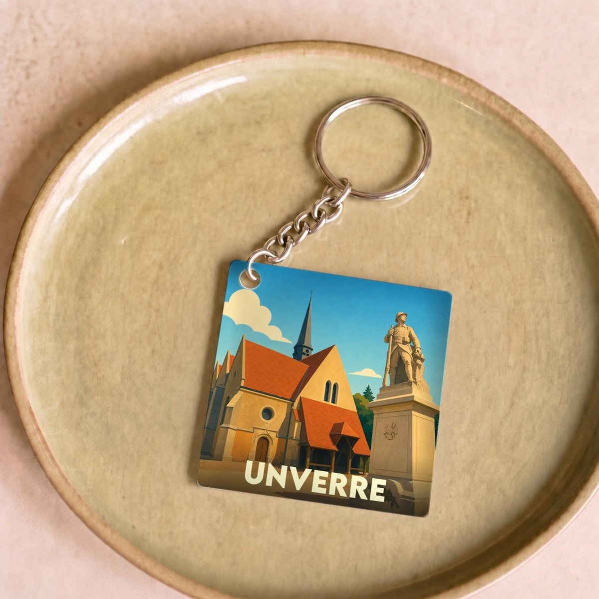 Porte-clés souvenir de la ville d'Unverre avec une illustration stylisée.