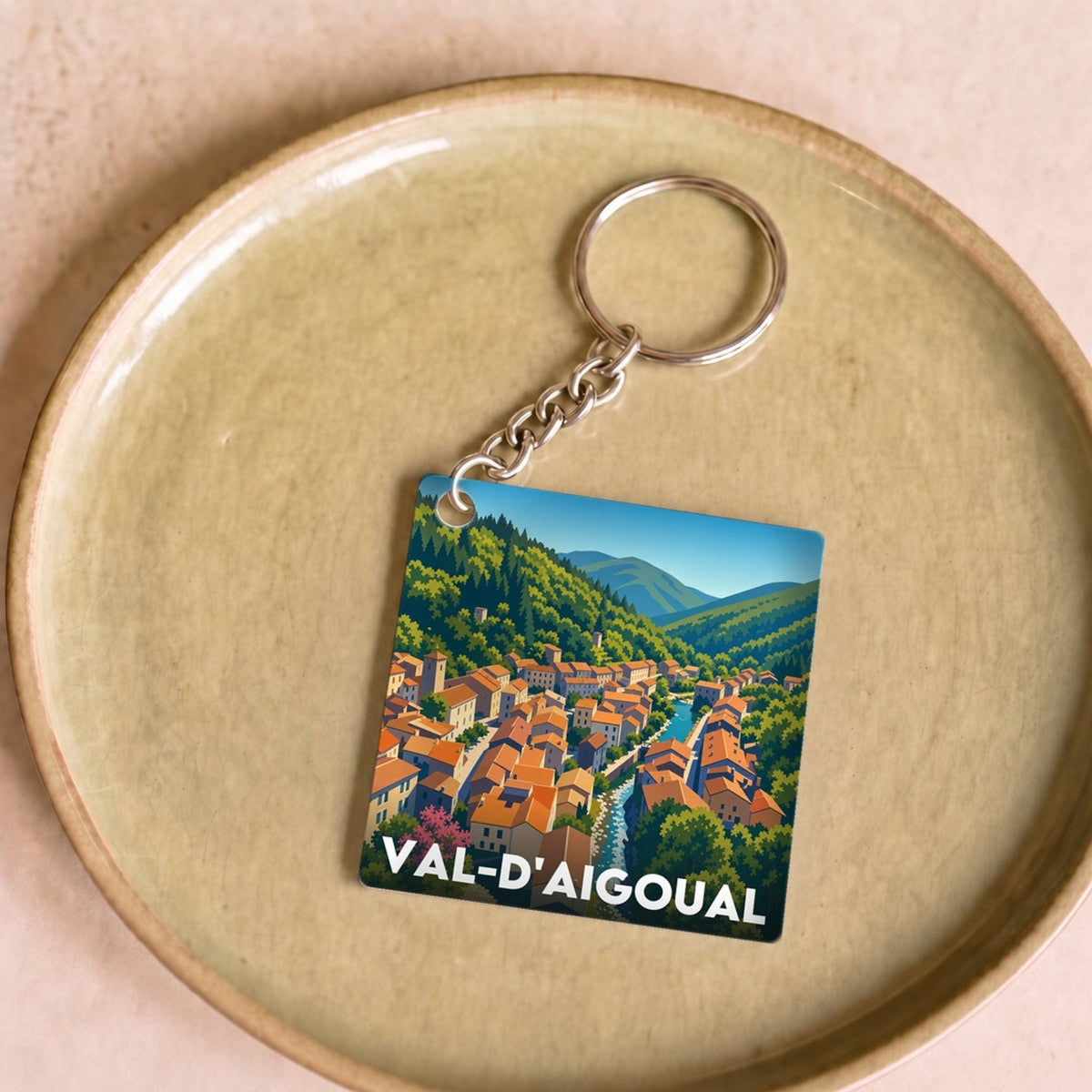 Porte-clés souvenir de la ville de Val-d'Aigoual avec une illustration stylisée.