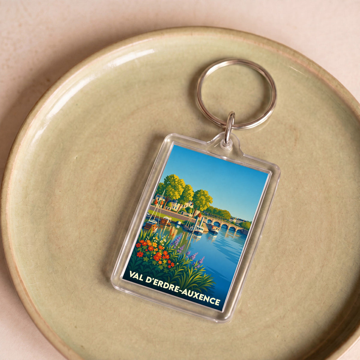 Porte-clés souvenir de Val d'Erdre-Auxence avec une illustration stylisée d'un bord de rivière.