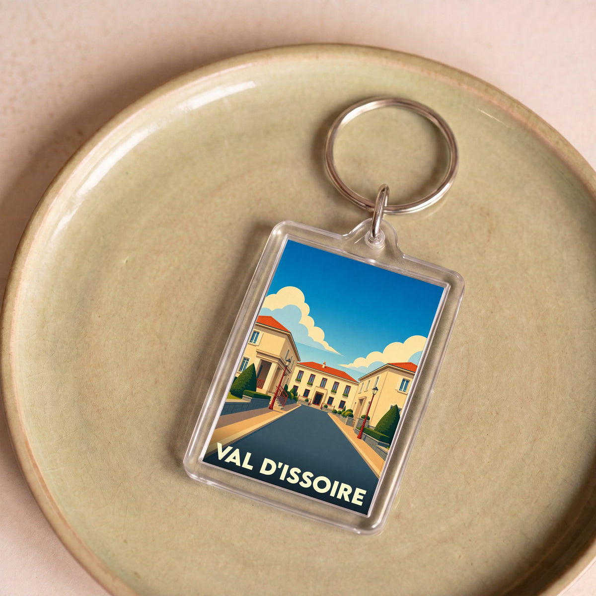 Porte-clés souvenir de Val d'Issoire avec une illustration stylisée de la ville.