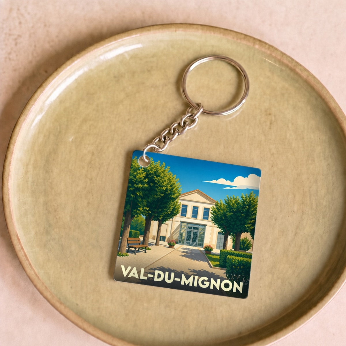 Porte-clés souvenir de la ville de Val-du-Mignon avec une illustration stylisée.
