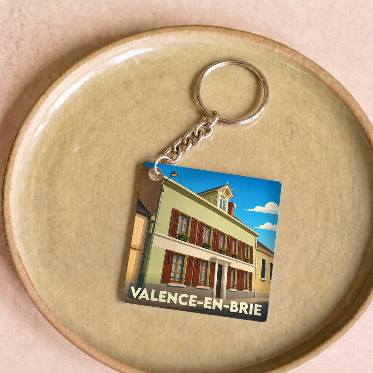 Porte-clés souvenir de Valence-en-Brie orné d'une illustration stylisée de la ville.