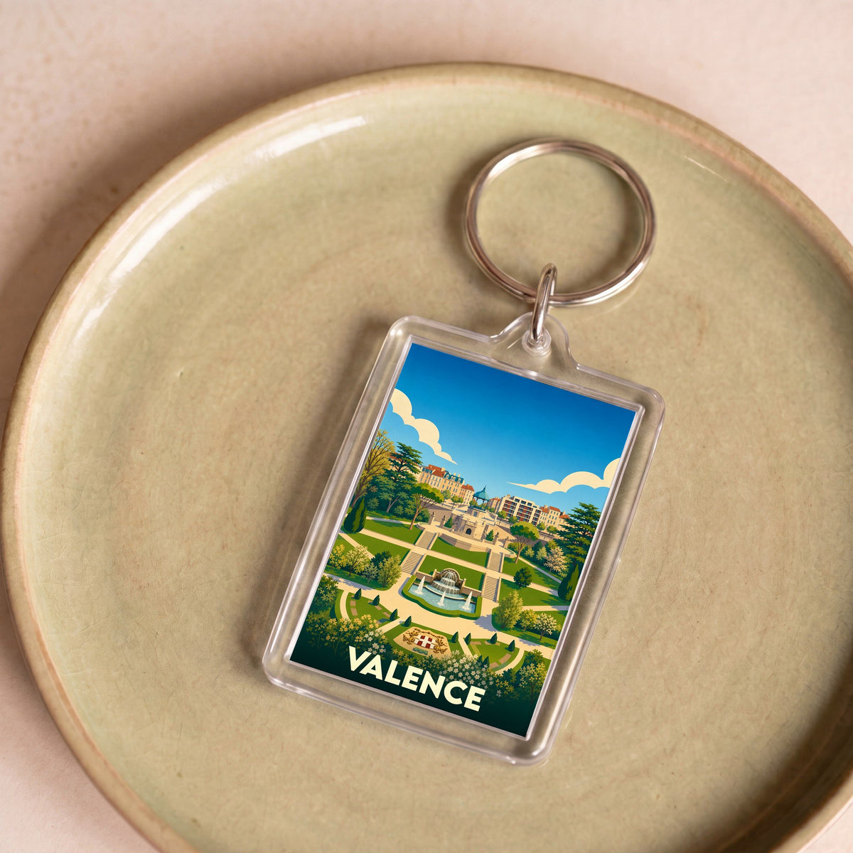 Porte-clés souvenir de la ville de Valence avec une illustration stylisée de son parc.