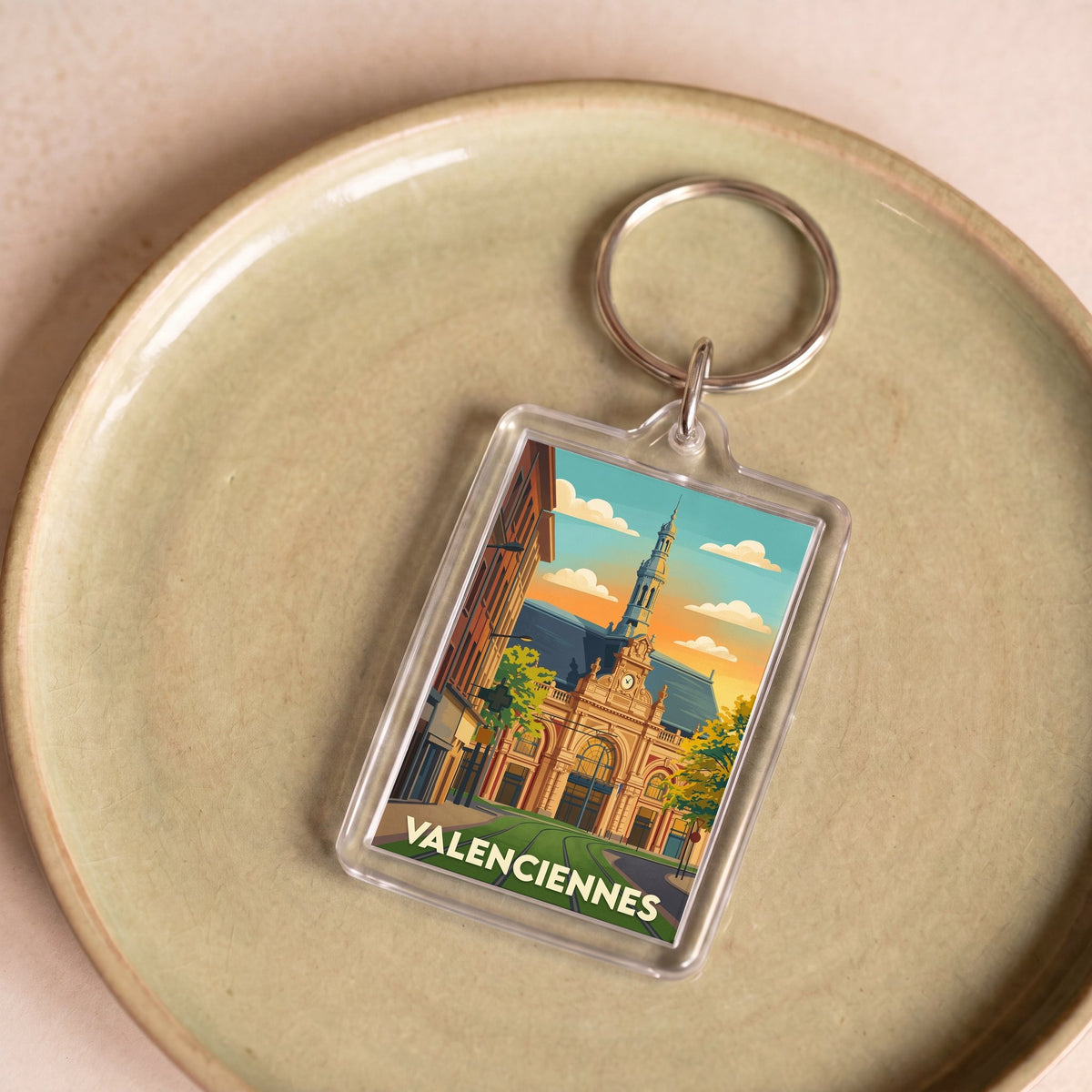 Porte-clés souvenir de la ville de Valenciennes avec une illustration stylisée.