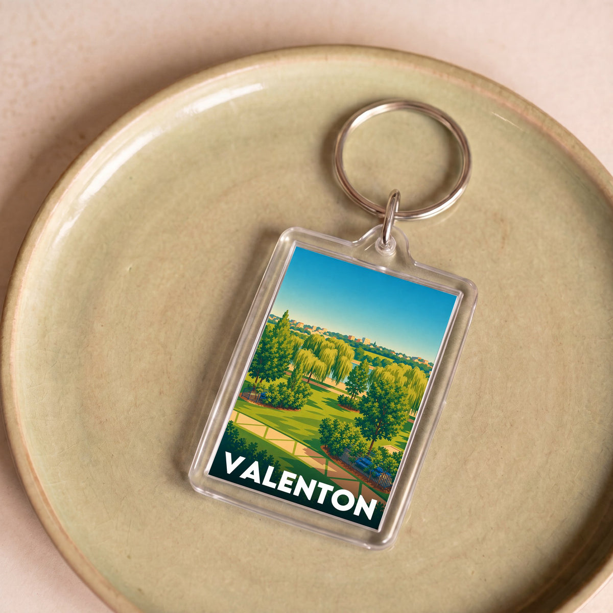 Porte-clés souvenir de la ville de Valenton avec une illustration stylisée d'un paysage verdoyant.