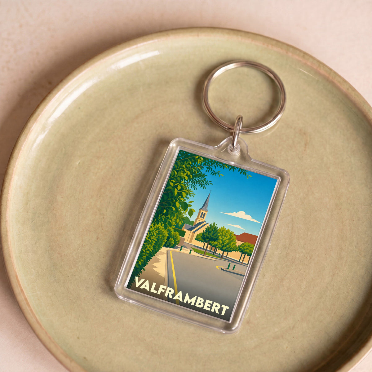 Porte-clés souvenir de la ville de Valframbert avec une illustration stylisée.