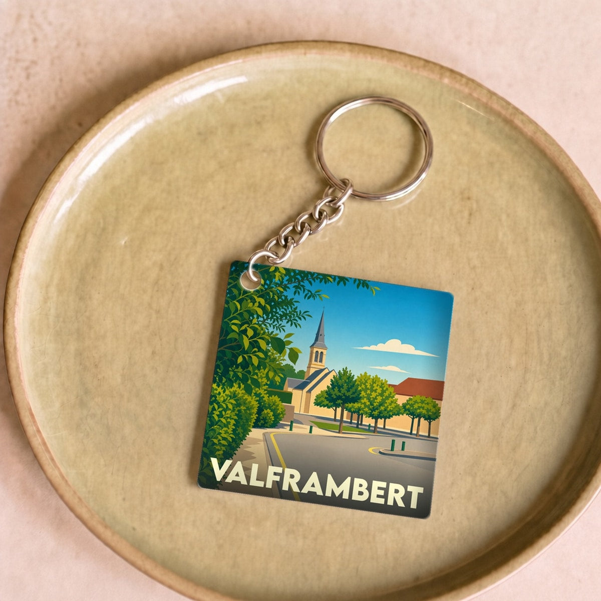 Porte-clés souvenir de la ville de Valframbert avec une illustration stylisée.