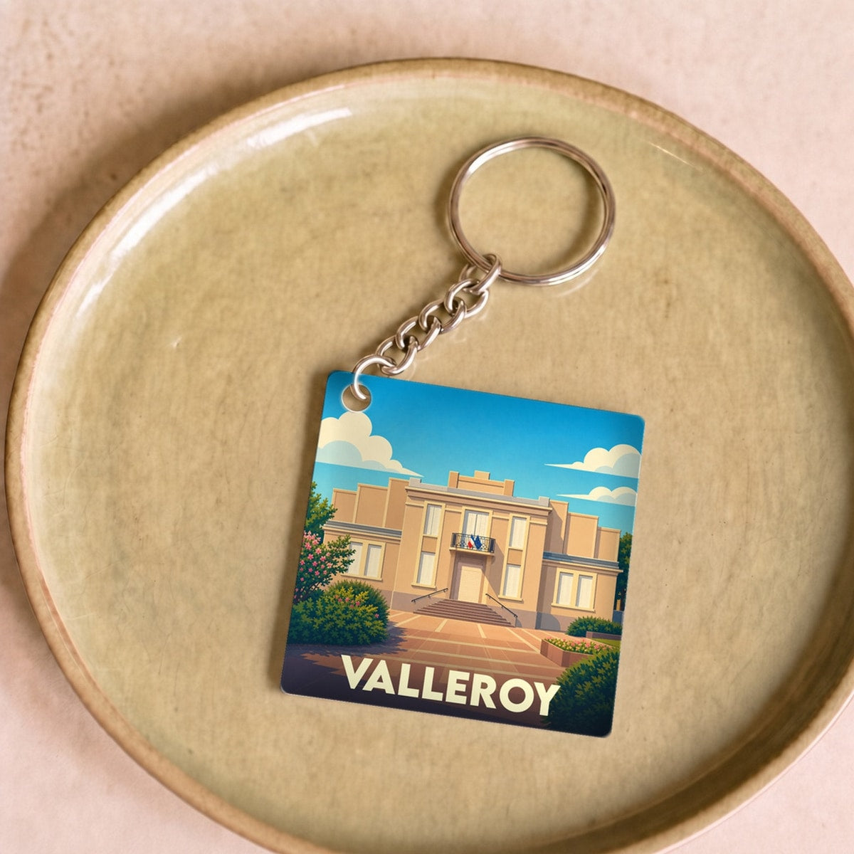 Porte-clés souvenir de la ville de Valleroy avec une illustration stylisée.