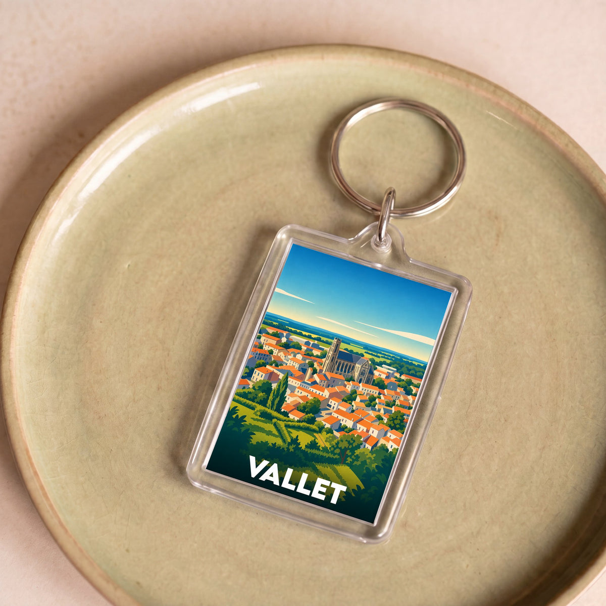 Porte-clés souvenir de la ville de Vallet avec une illustration stylisée.