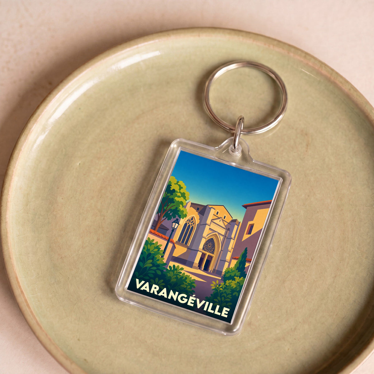 Porte-clés souvenir de la ville de Varangéville avec une illustration stylisée d'un monument historique.