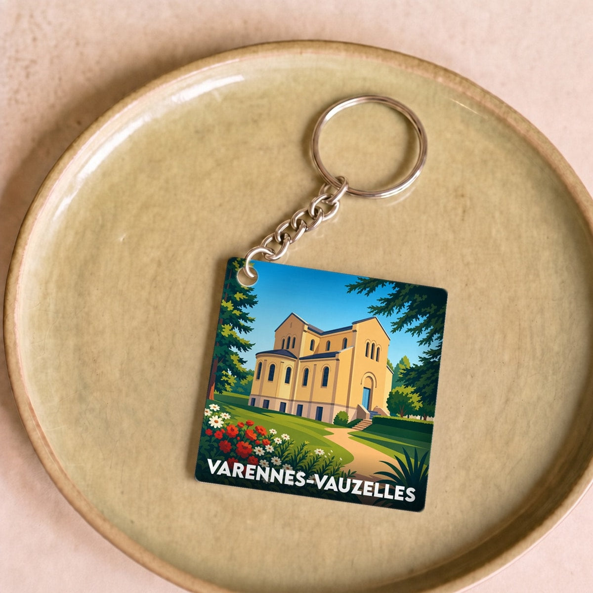 Porte-clés souvenir de la ville de Varennes-Vauzelles avec une illustration stylisée.