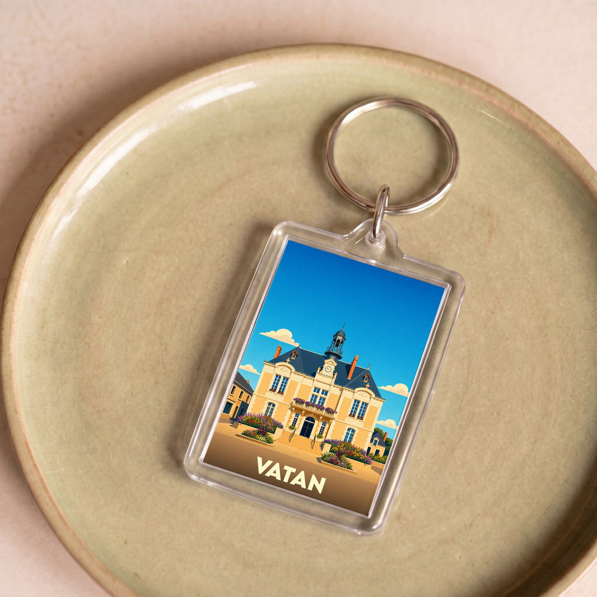 Porte-clés souvenir de la ville de Vatan avec une illustration stylisée de son hôtel de ville.